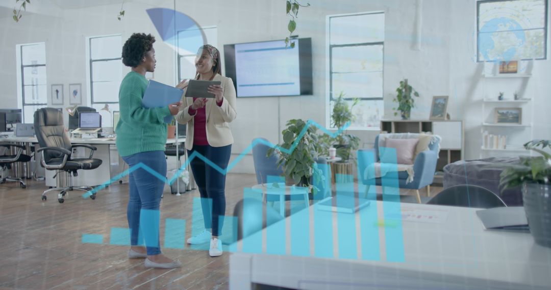 Businesswomen Analyzing Financial Data with Bar Graph Overlay; Modern Office Setting - Free Images, Stock Photos and Pictures on Pikwizard.com