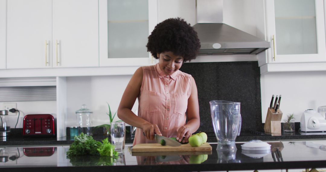 African American Woman Chopping Vegetables in Modern Kitchen at Home - Free Images, Stock Photos and Pictures on Pikwizard.com