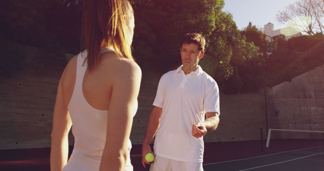 Tennis Coach Instructing Female Player on Outdoor Court - Free Images, Stock Photos and Pictures on Pikwizard.com