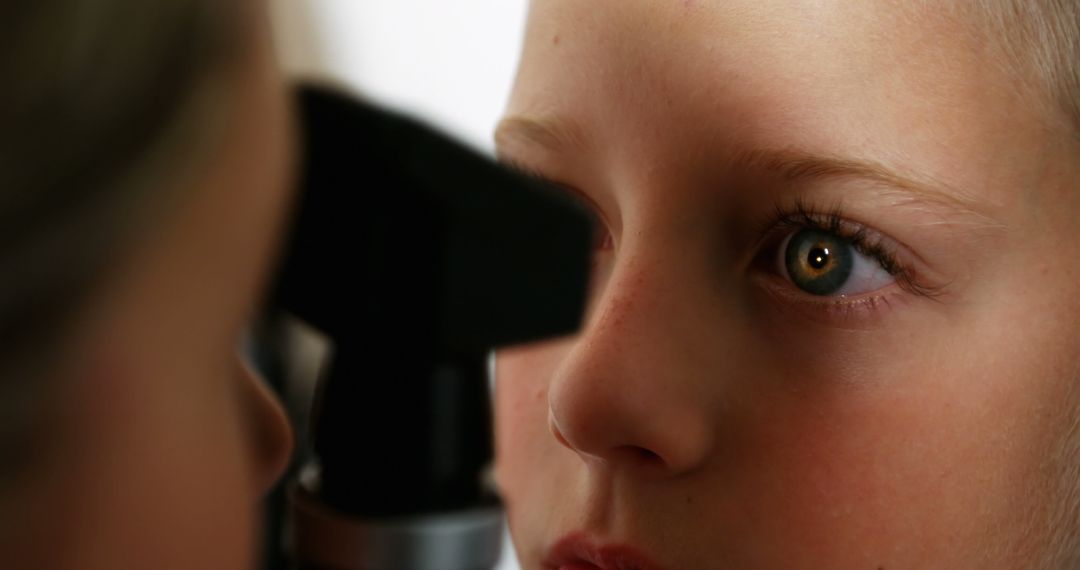 Doctor Examining Child's Eye with Ophthalmoscope - Free Images, Stock Photos and Pictures on Pikwizard.com