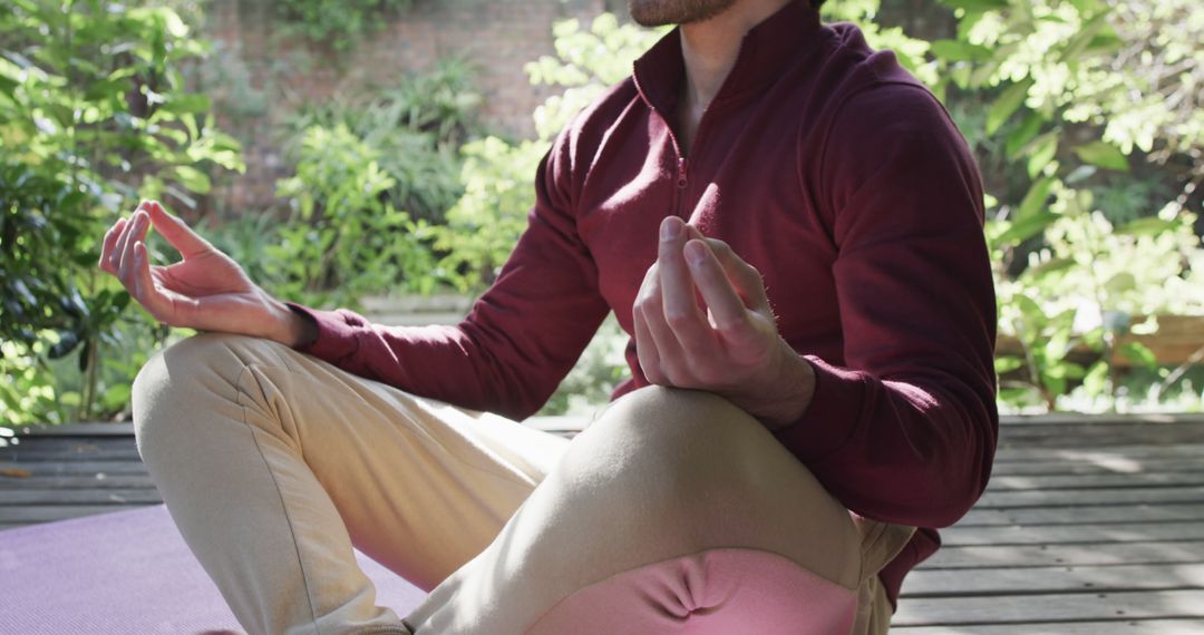 Relaxed Young Man Meditating Outdoors on Wooden Deck - Free Images, Stock Photos and Pictures on Pikwizard.com