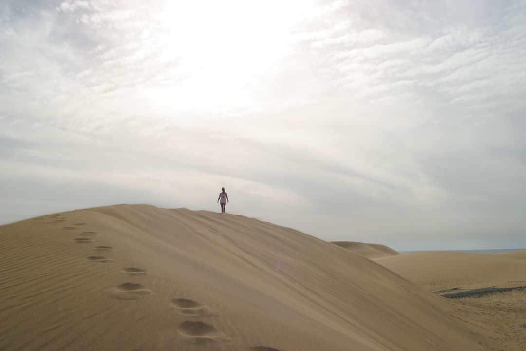 Lone Traveler in Expansive Desert Dunes at Sunset - Free Images, Stock Photos and Pictures on Pikwizard.com