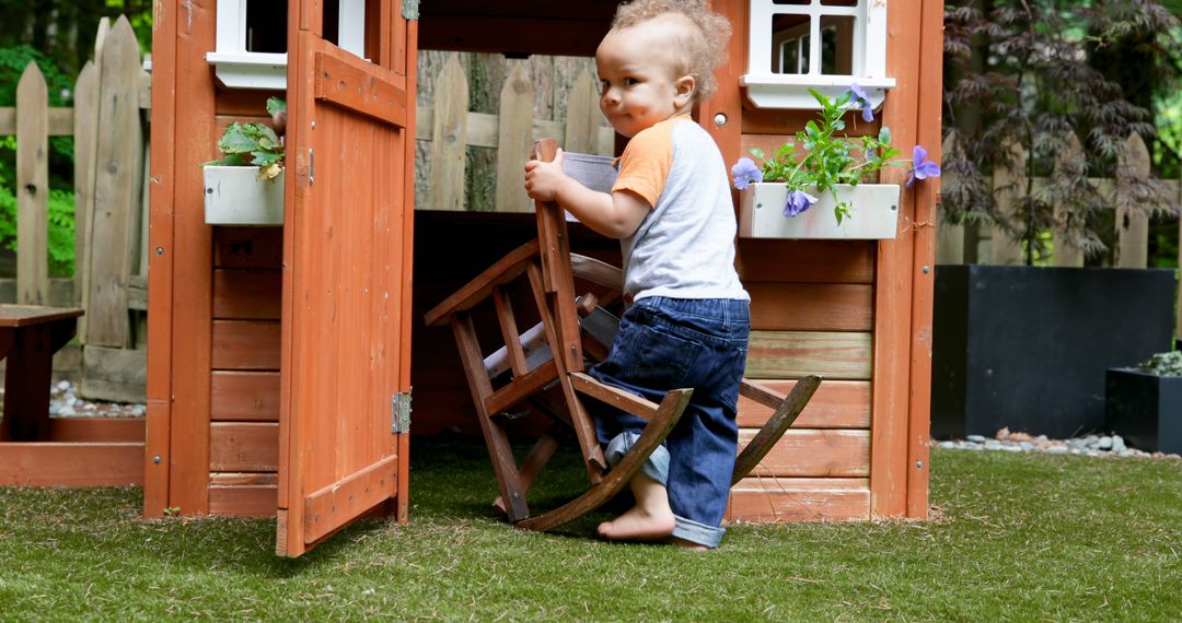 Toddler Playing in Wooden Playhouse in Backyard - Free Images, Stock Photos and Pictures on Pikwizard.com