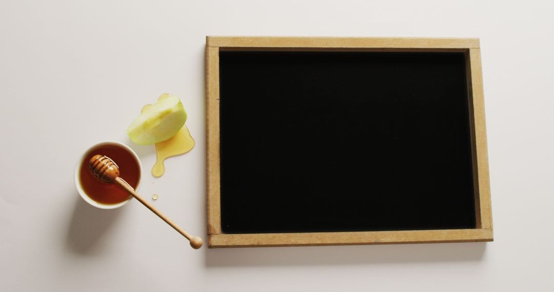 Empty Blackboard with Honey and Slice of Apple on White Background - Free Images, Stock Photos and Pictures on Pikwizard.com