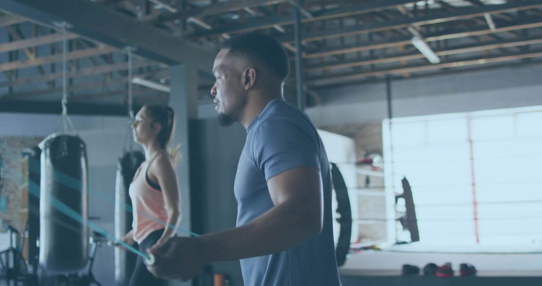 Athletic Man Skipping Rope in Modern Boxing Gym