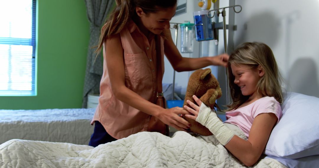 Mother comforting daughter with teddy bear in hospital bed - Free Images, Stock Photos and Pictures on Pikwizard.com