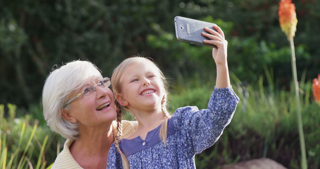 Grandmother and Granddaughter Taking Selfie in the Park - Free Images, Stock Photos and Pictures on Pikwizard.com