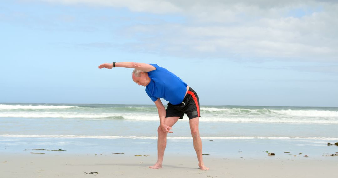 Senior Man Stretching on Beach for Active Healthy Lifestyle - Free Images, Stock Photos and Pictures on Pikwizard.com