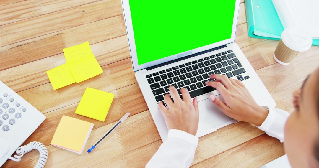 Person Using Laptop with Green Screen on Office Desk - Free Images, Stock Photos and Pictures on Pikwizard.com