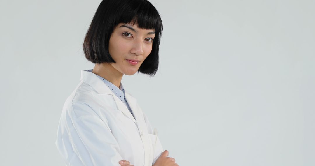 Confident Female Scientist in Lab Coat Posing Against White Background - Free Images, Stock Photos and Pictures on Pikwizard.com