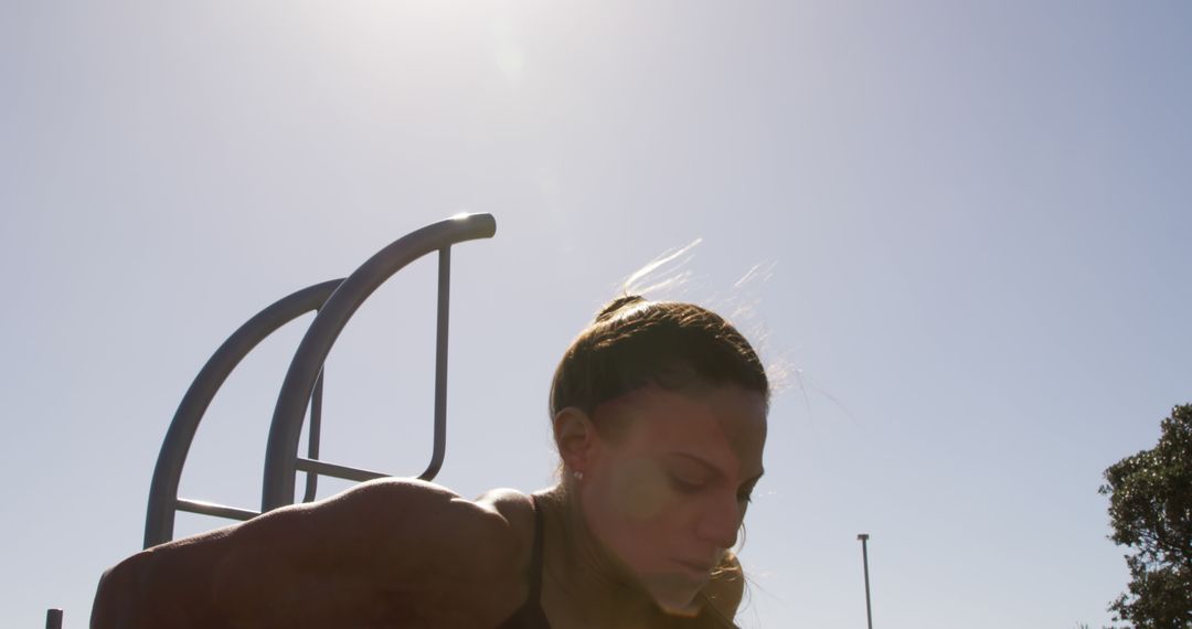 Woman Exercising in Outdoor Gym Under Sunlight - Free Images, Stock Photos and Pictures on Pikwizard.com