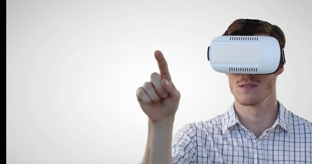 Man Using Virtual Reality Headset Against Neutral Background