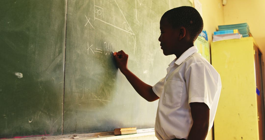 Student Solving Math Problem on Green Chalkboard - Free Images, Stock Photos and Pictures on Pikwizard.com