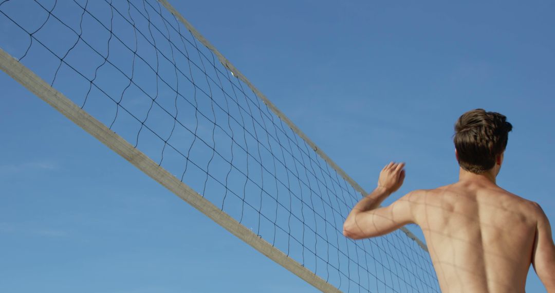 Fit Man Playing Beach Volleyball Under Clear Sky - Free Images, Stock Photos and Pictures on Pikwizard.com