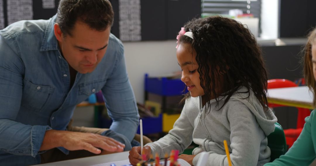 Engaged Teacher Helping Student Learning in Classroom