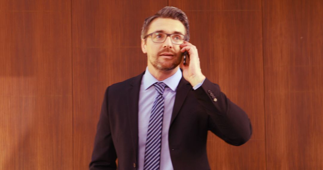 Businessman in Suit Taking Important Call in Office - Free Images, Stock Photos and Pictures on Pikwizard.com