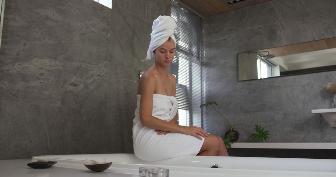 Woman Relaxing in Modern Bathroom with Towel and Turban After Bath - Free Images, Stock Photos and Pictures on Pikwizard.com