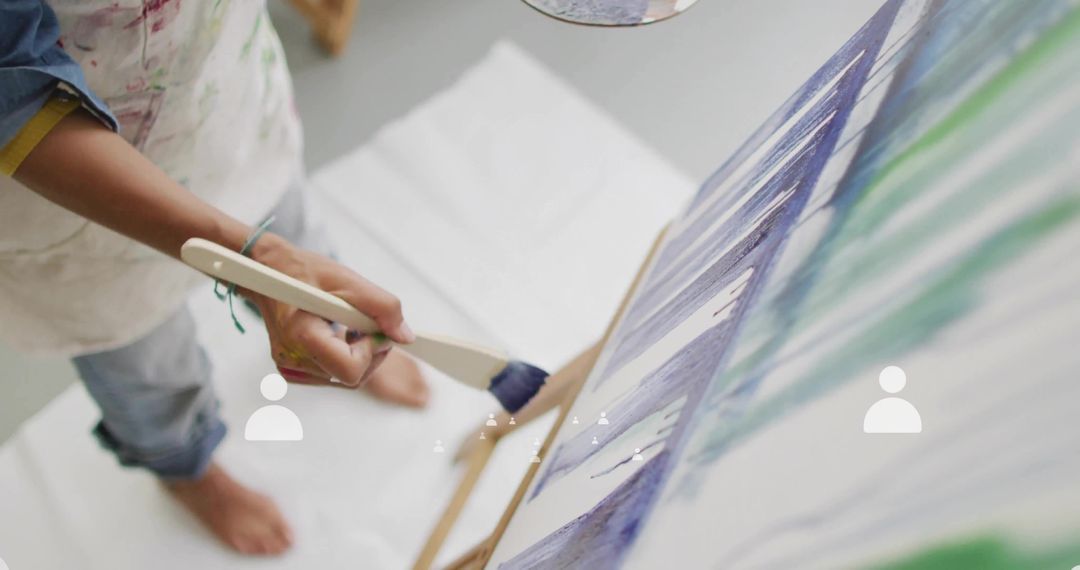 Artist Creating Abstract Painting on Canvas with Brush Strokes