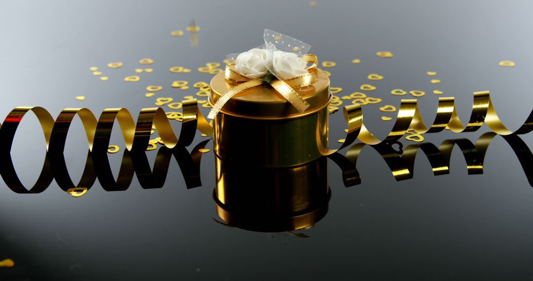 A black gift box with a white bow and gold confetti implies a festive celebration. - Free Images, Stock Photos and Pictures on Pikwizard.com