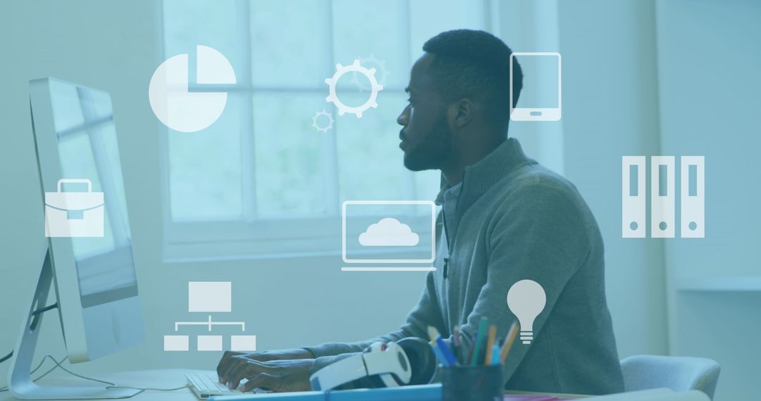 African American Man Analyzing Data on Computer in Office