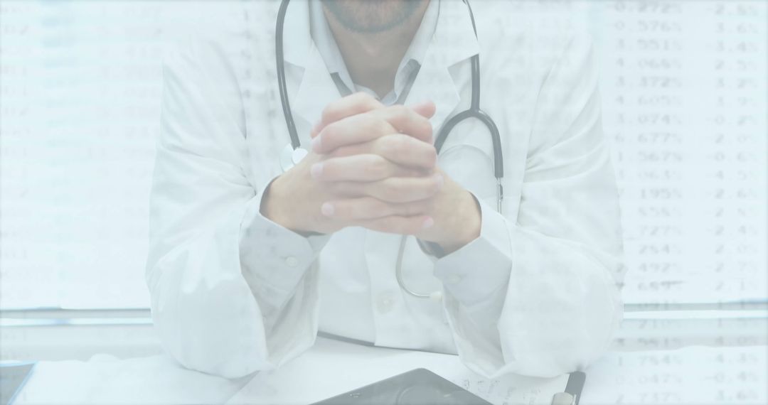 Doctor in Consultation Room Using Digital Tablet with Stethoscope Closeup