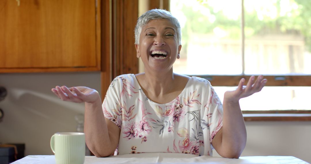 Happy Senior Woman Laughing During a Video Call at Home