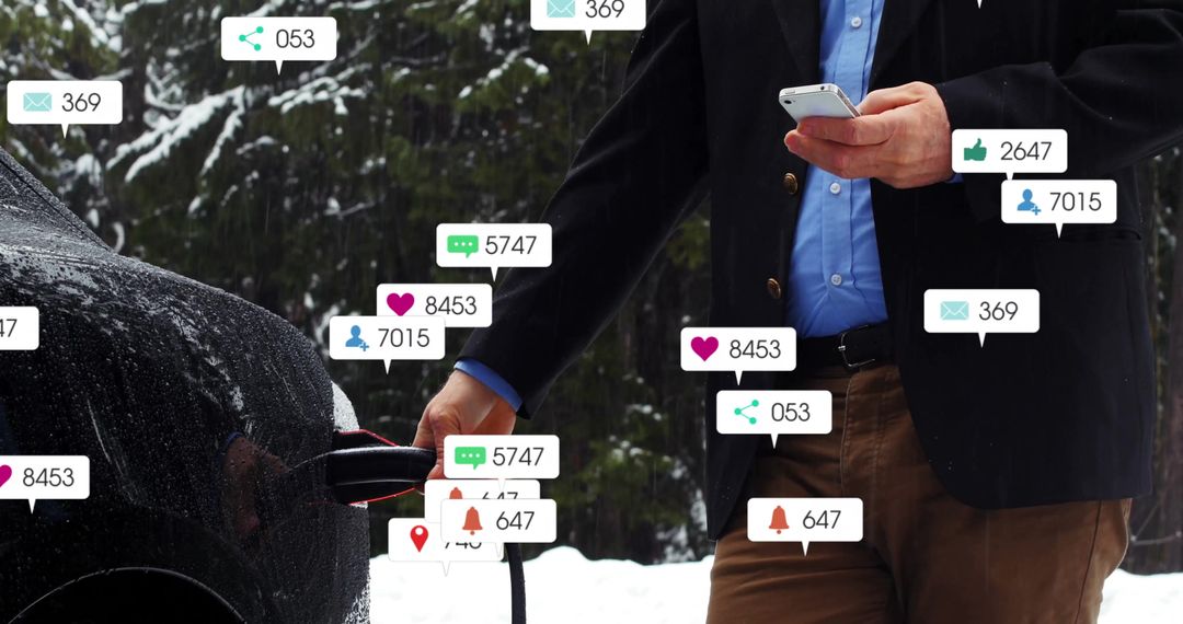 Man Charging Electric Car Using Smartphone in Snowy Forest