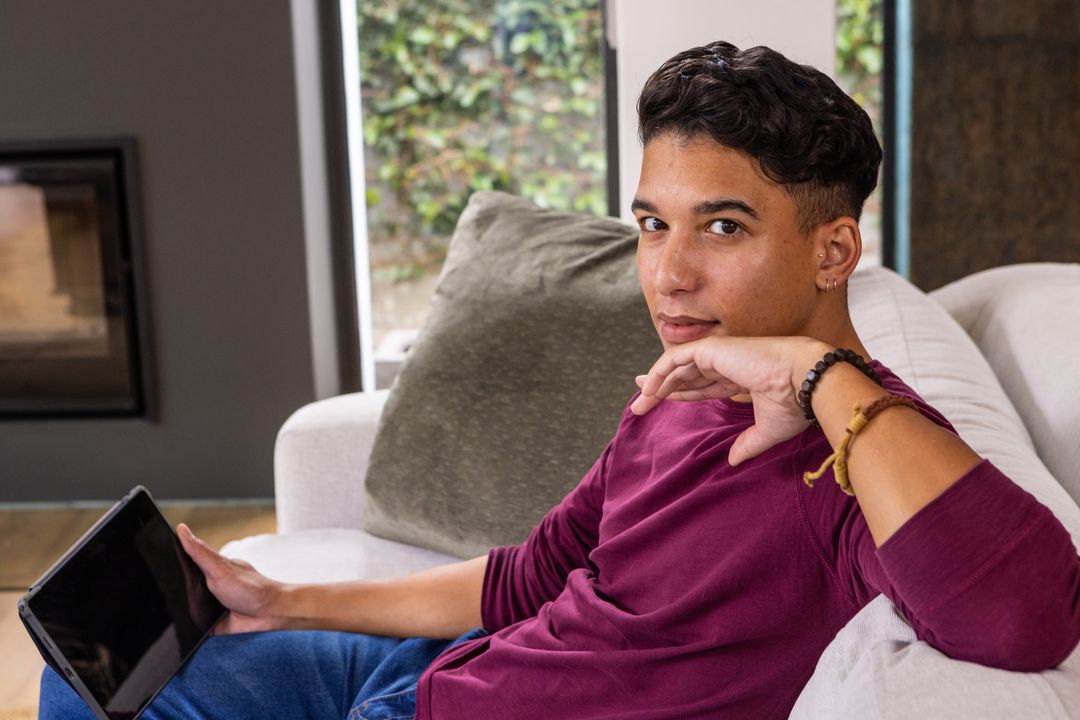 Man Relaxing with Tablet on Modern Sofa in Stylish Living Room