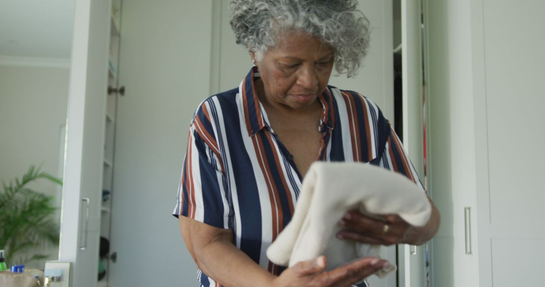 African american senior woman packing suitcase for travel - Free Images, Stock Photos and Pictures on Pikwizard.com