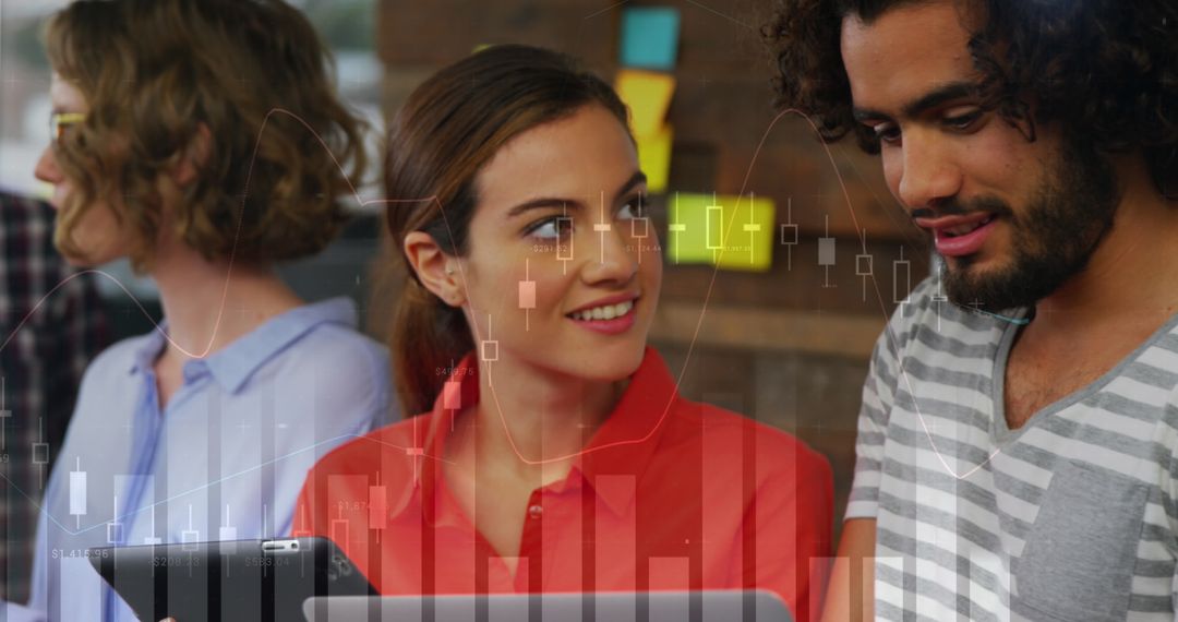 Young Analysts Engaged in Teamwork with Stock Graph Overlay