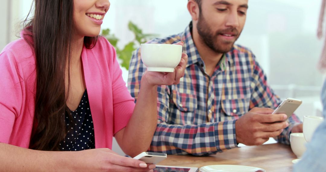 Happy Colleagues Using Smartphones in Office Environment