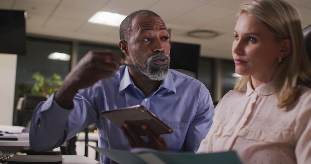 Diverse Professionals Collaborating Over Digital Tablet