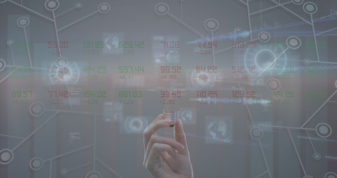 Hand Holding Bulb Amidst Futuristic Data Display