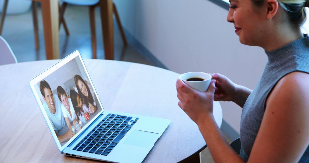 Woman Engages in Video Call with Family on Laptop - Free Images, Stock Photos and Pictures on Pikwizard.com