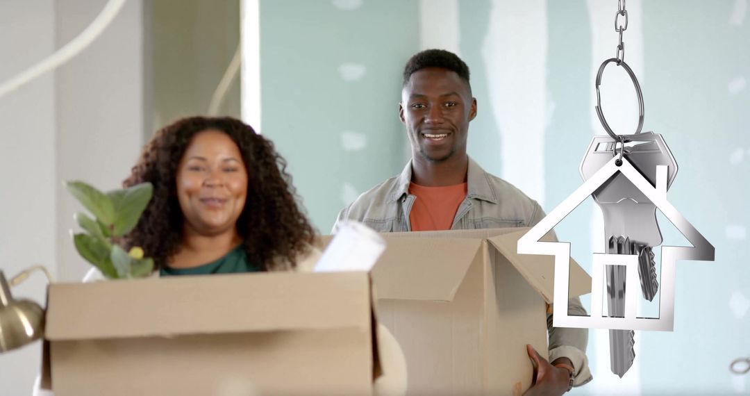 Excited Couple Moving into New Home Holding Boxes and Keys