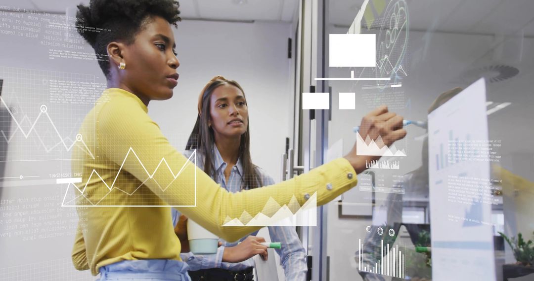 Sketching Data on Glass Partition While Female Colleagues Collaborating on Analytics