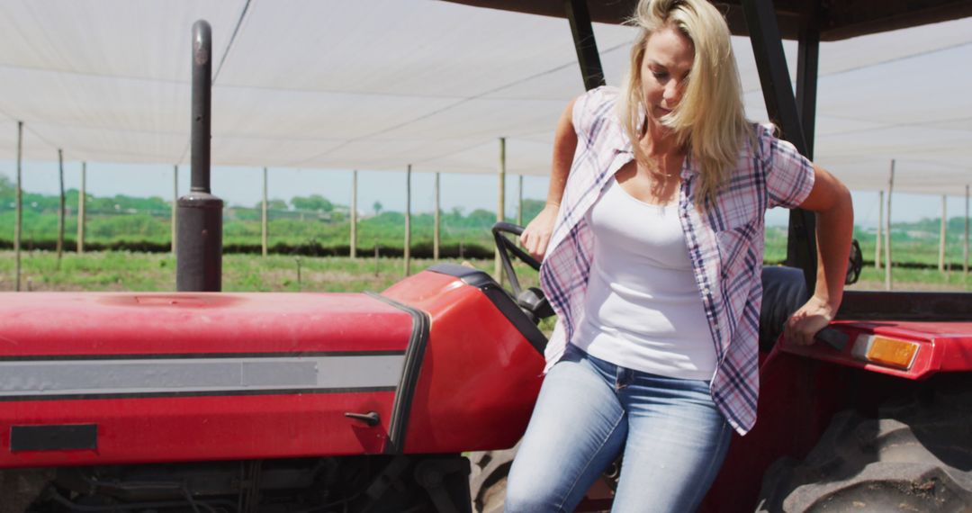 Female Farmer Getting Off Tractor in Field - Free Images, Stock Photos and Pictures on Pikwizard.com