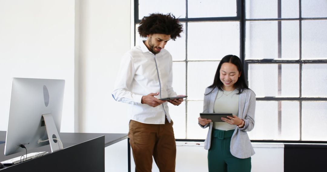 Colleagues Collaborating in Modern Office Using Tablets