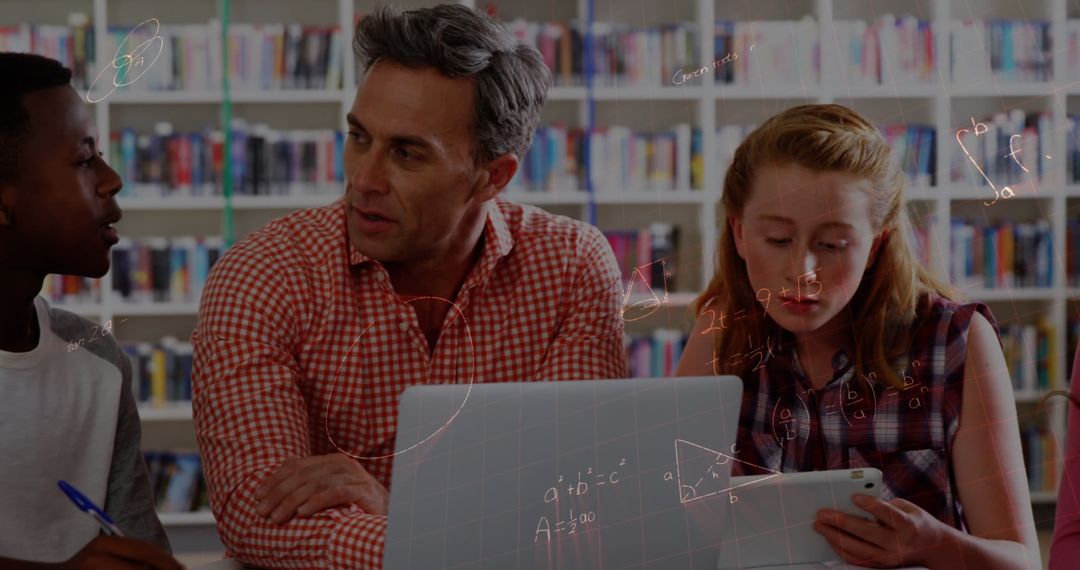 Teacher Guiding Students with Mathematics on Laptop in Modern Classroom