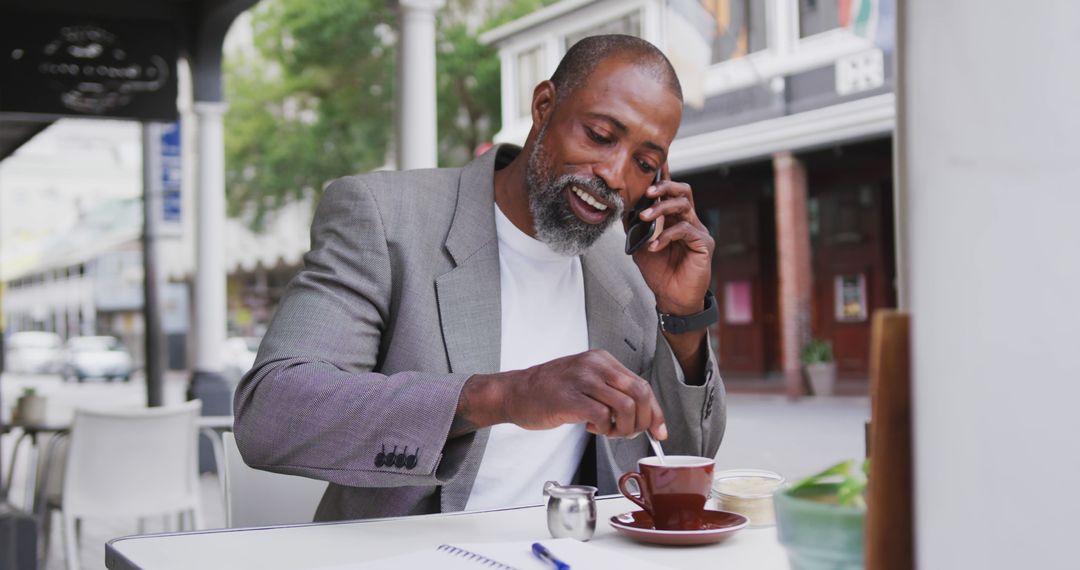 Mature Man in Cafe Enjoying Coffee and Phone Call Outdoors