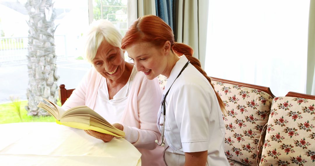 Nurse And Elderly Woman Sitting Together And Reading Book - Free Images, Stock Photos and Pictures on Pikwizard.com