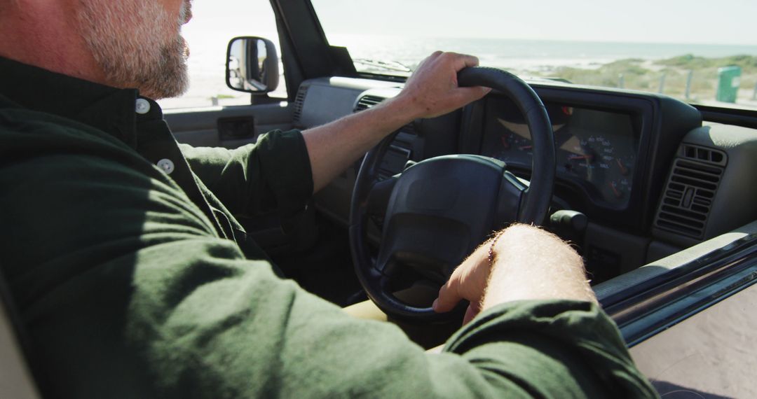 Man Driving Car along Scenic Coastal Road with Ocean View - Free Images, Stock Photos and Pictures on Pikwizard.com