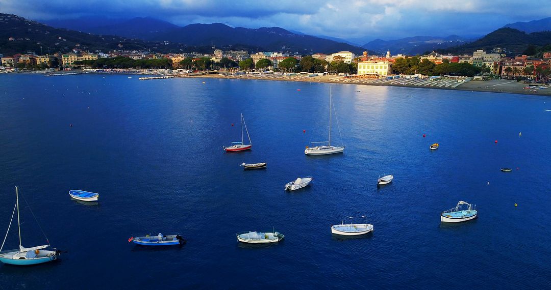 Scenic Bay with Boats on Calm Blue Water against Mountain Backdrop - Free Images, Stock Photos and Pictures on Pikwizard.com