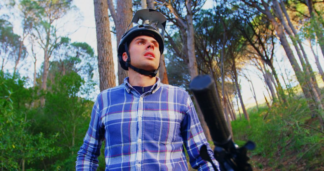 Young Man Mountain Biking in Forest Wearing Plaid Shirt and Protective Gear - Free Images, Stock Photos and Pictures on Pikwizard.com