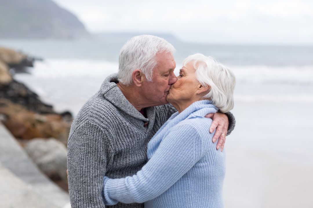 Senior Couple Kissing on Beach - Free Images, Stock Photos and Pictures on Pikwizard.com
