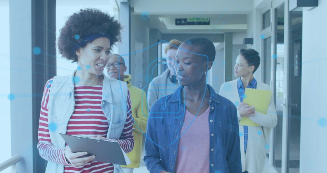 Professional Team Discussing Innovation in Bright Corridor