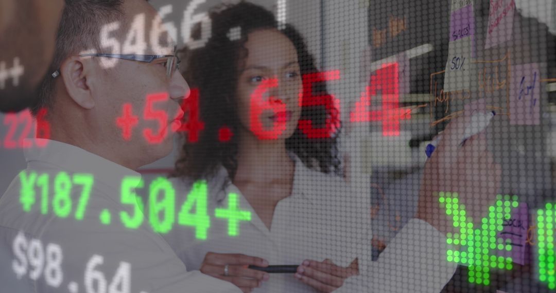 Diverse Business Colleagues Discussing Financial Data on Digital Interface