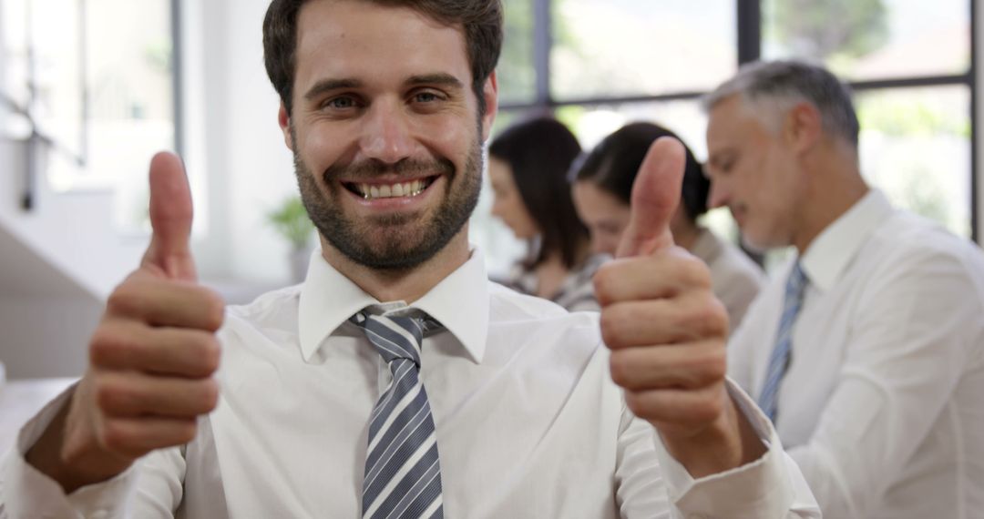 Professional Man Smiling and Giving Double Thumbs Up in Office - Free Images, Stock Photos and Pictures on Pikwizard.com