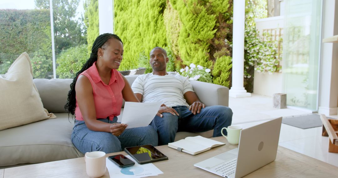 Couple Collaborating on Finances with Digital Devices
