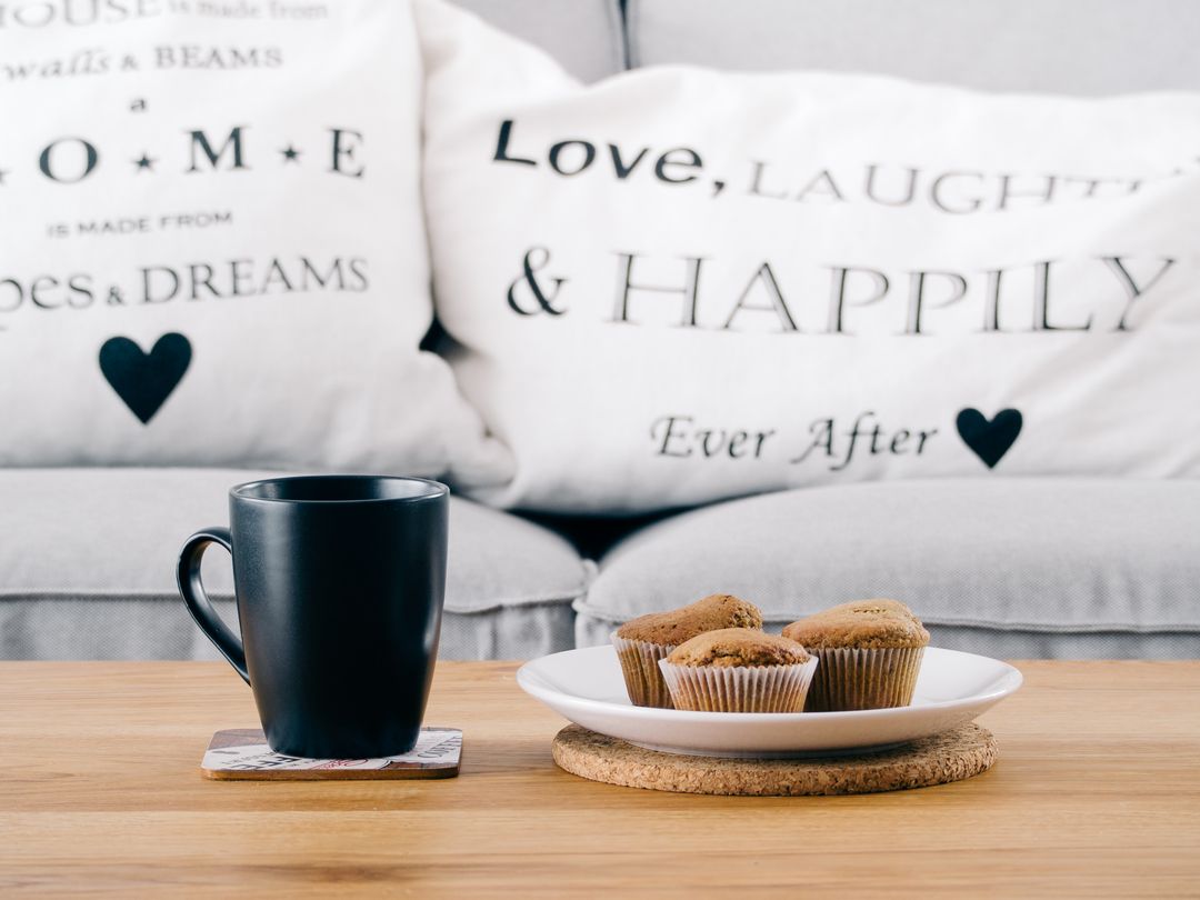 Cozy Coffee Mug and Muffins on Wooden Table with Inspirational Pillows - Free Images, Stock Photos and Pictures on Pikwizard.com